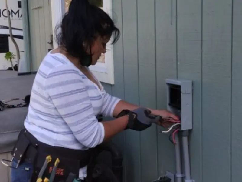 Licensed electrician wiring an exterior subpanel in Grover Beach